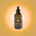 Bottle of 'GLOW Starshine' rich body oil on a gradient orange background