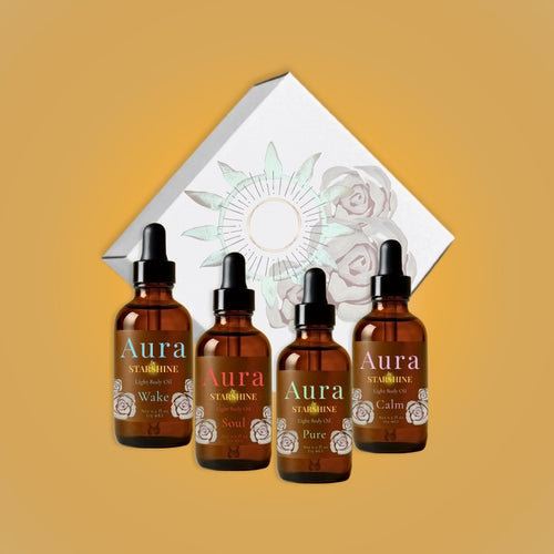 4 brown bottles in front of a white box, all bottles say "aura" lavender, peppermint, eucalyptus, tea tree, and frankincense scents