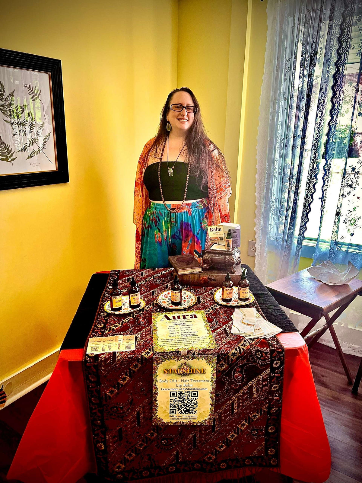 Christina Weir, who also goes by Starshine, stands behind a vending booth table full of oils to sample and products for purchase. The room surrounding her booth serves as a yoga studio to people in and around Dallas, Georgia. Click the image to navigate to the founder’s instagram profile. 