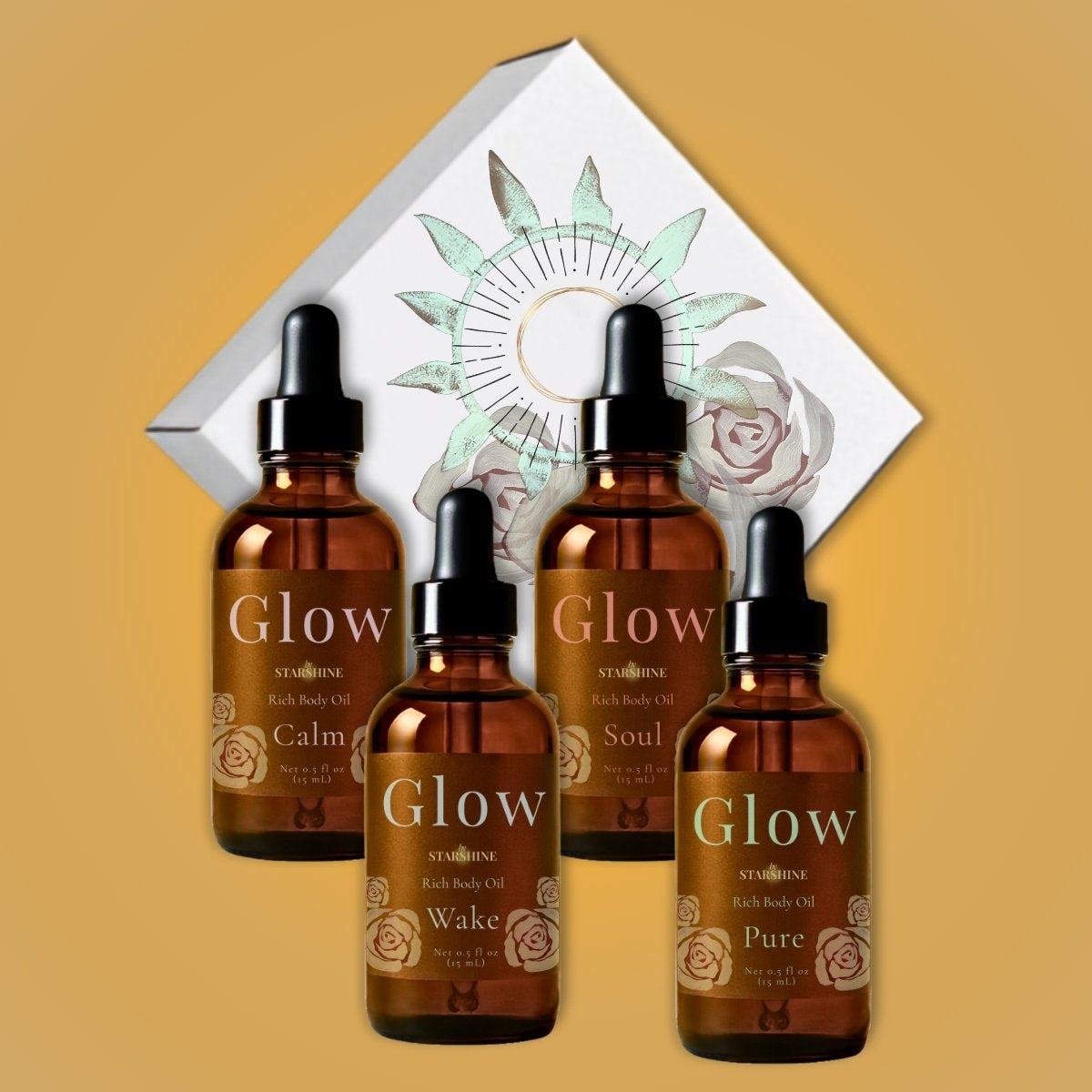 Four amber glass dropper bottles of Glow body oils arranged in front of a white decorative box with a sun and rose illustration on a warm tan background. Scents are frankincense, lavender, peppermint and eucalyptus, and tea tree.