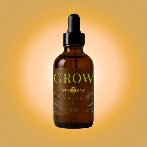 Brown glass bottle of 'Grow by Starshine' hair and scalp oil on a gradient orange background