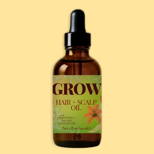 A 1 fl oz amber glass dropper bottle of Grow Hair and Scalp Oil with Peppermint and Eucalyptus, centered against a solid pale yellow background.