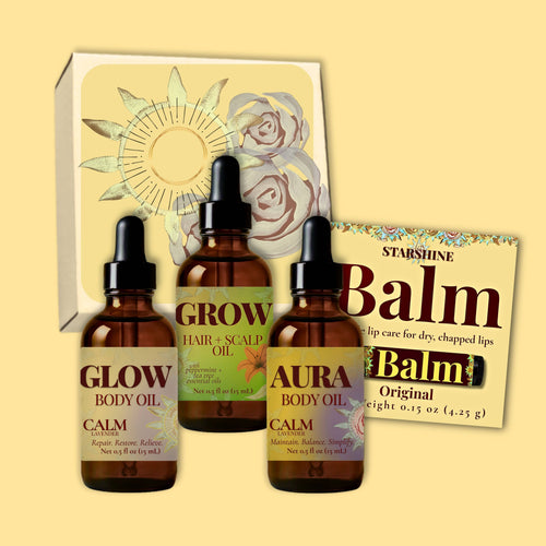 Three amber dropper bottles of body and scalp oils in front of a decorative box, with a Starshine Balm card behind them, on a pale yellow background.