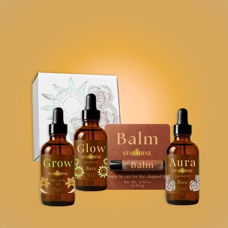 three bottles and a lip balm and a box including, "grow," "glow," and "aura," and "balm"