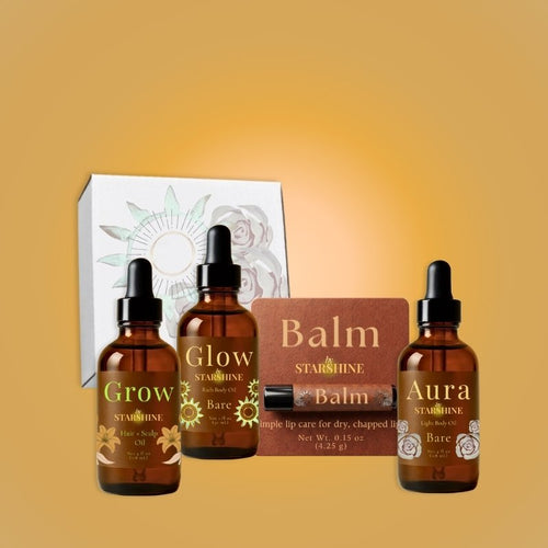 three bottles and a lip balm and a box including, "grow," "glow," and "aura," and "balm"